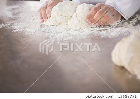 Close up of baker preparing dough 13685751