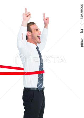 Happy businessman crossing the finish line and pointing up 13686000
