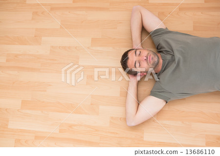 A man lying on floor at home 13686110