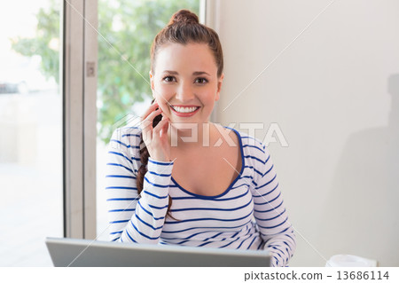 Pretty brunette catching up on work 13686114