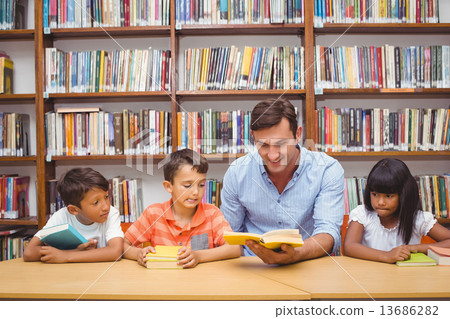 Cute pupils and teacher reading in library Cute pupils and teacher reading in library 13686282
