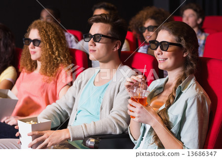 Young friends watching a 3d film 13686347