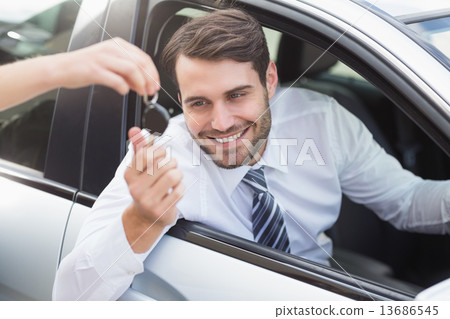 Businessman getting his new car key Businessman getting his new car key 13686545