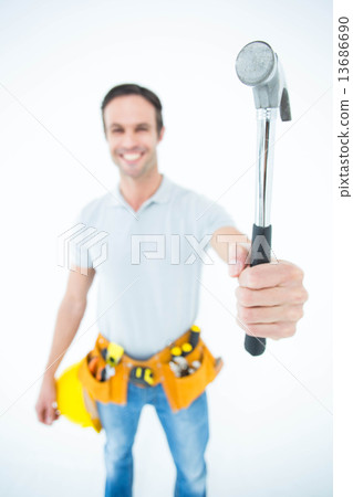 Confident technician holding hammer over white background Confident technician holding hammer over white background 13686690