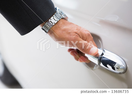 Man holding a car door handles Man holding a car door handles 13686735