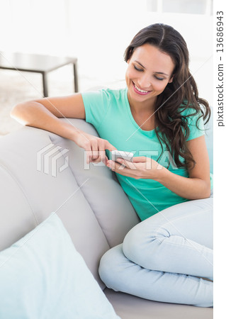 Pretty brunette texting on the phone Pretty brunette texting on the phone 13686943