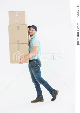 Delivery man carrying cardboard boxes 13687210