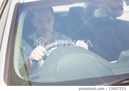 Focused man sitting at the wheel 13687253