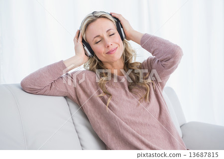 Smiling blonde eyes closed enjoying and listening music Smiling blonde eyes closed enjoying and listening music 13687815