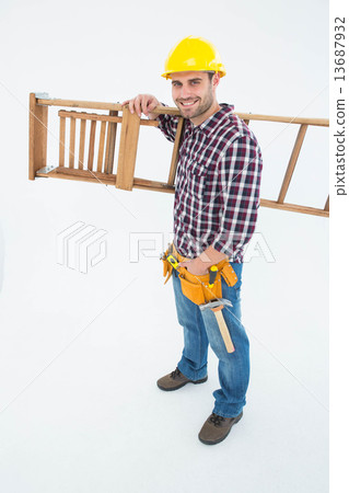 Confident handyman carrying ladder 13687932