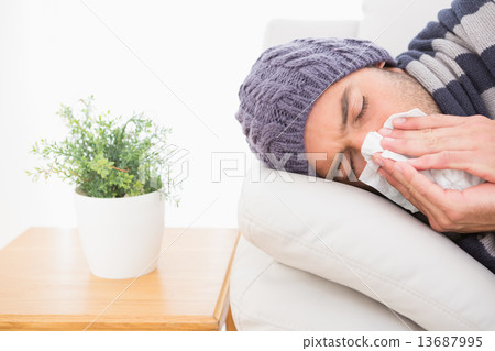 A sick man lying on the sofa A sick man lying on the sofa 13687995