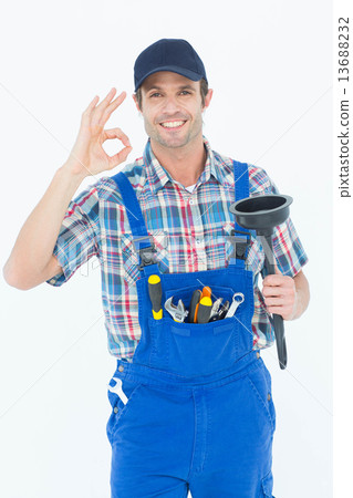 Plumber holding plunger while gesturing OK sign Plumber holding plunger while gesturing OK sign 13688232