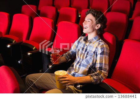 Young man watching a film 13688441