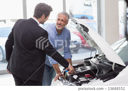 Two men looking at a car engine Two men looking at a car engine 13688552