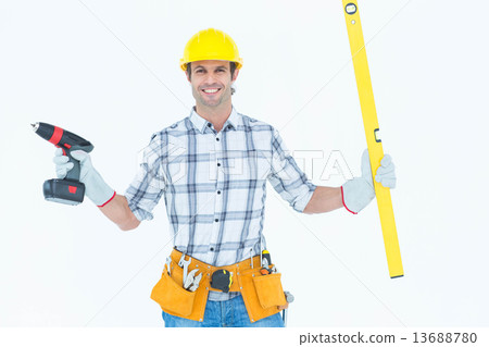 Technician holding portable drill and spirit level 13688780