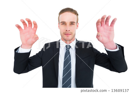 Serious businessman with hands up 13689137