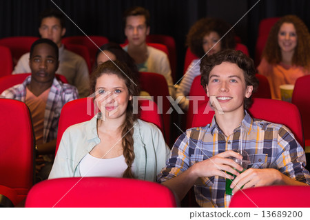 Young couple watching a film Young couple watching a film 13689200