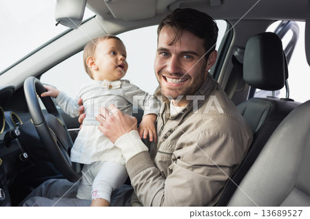 Father playing with baby in drivers seat Father playing with baby in drivers seat 13689527