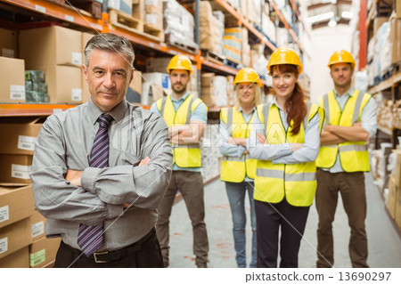 Smiling warehouse team with arms crossed 13690297