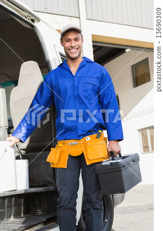 Smiling handsome handyman holding toolbox 13690309