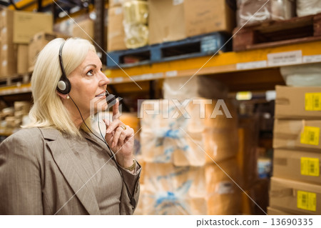 Warehouse manager giving orders on headset Warehouse manager giving orders on headset 13690335