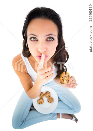 Pretty brunette eating plate of cookies Pretty brunette eating plate of cookies 13690459