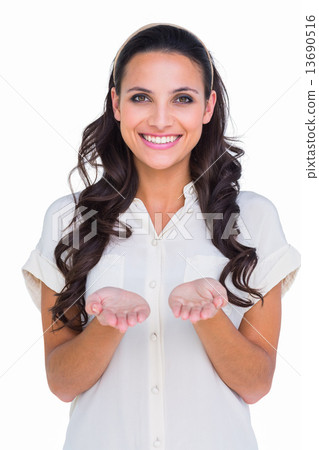 Pretty brunette holding out hands 13690516