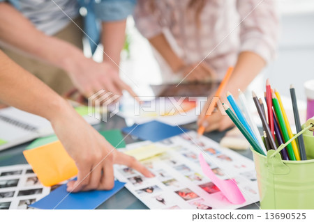 Teamwork briefing and editing photos together 13690525