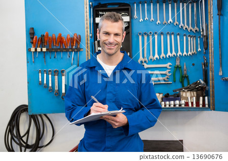 Smiling mechanic looking at camera 13690676