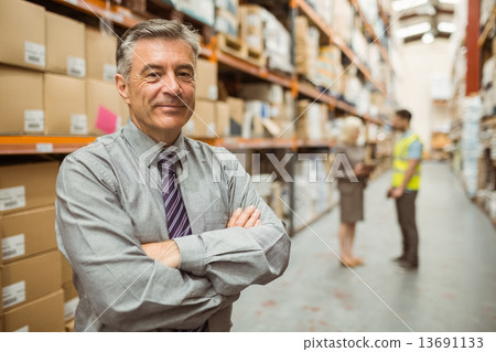 Smiling businessman with crossed arms Smiling businessman with crossed arms 13691133