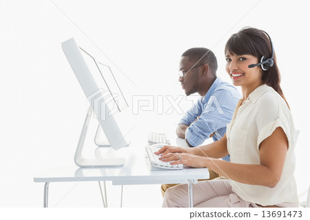Smiling teamwork using computer and headset 13691473