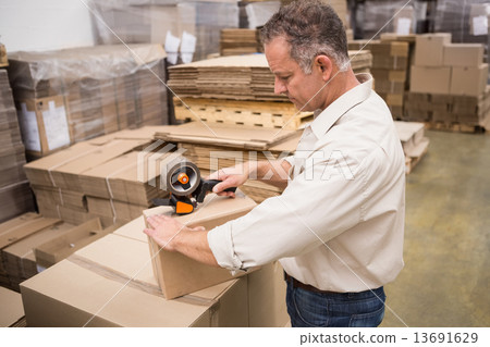Warehouse worker preparing a shipment 13691629