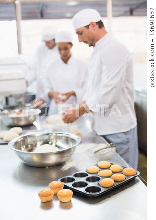 Team of bakers working at counter Team of bakers working at counter 13691632