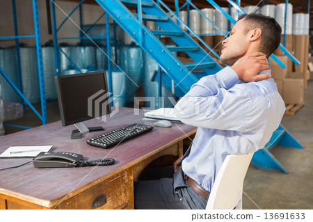 Warehouse manager working on computer Warehouse manager working on computer 13691633