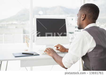 Stock Photo: Casual man working at desk with computer and digitizer