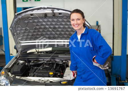 Mechanic smiling at the camera 13691767