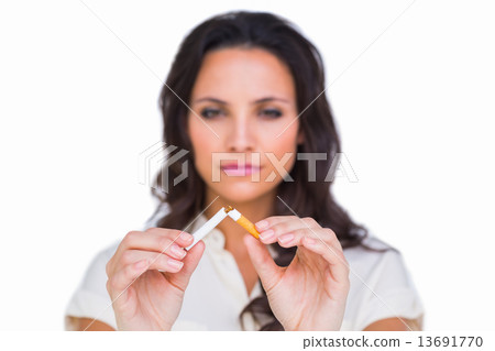 Pretty brunette breaking a cigarette Pretty brunette breaking a cigarette 13691770