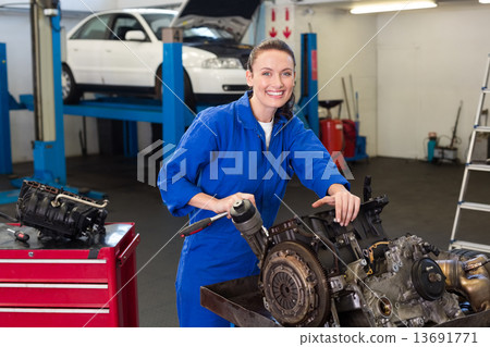 Mechanic working on an engine Mechanic working on an engine 13691771
