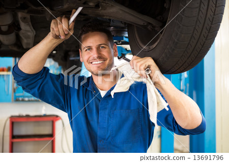 Mechanic examining under the car Mechanic examining under the car 13691796