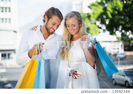 Attractive couple looking at shopping purchases 13692389