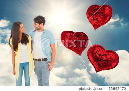 Composite image of happy casual couple smiling at each other 13692470