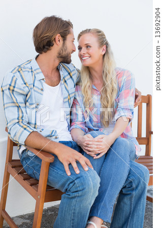 Attractive couple sitting on bench 13692904