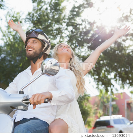 Cute couple riding a scooter 13693034