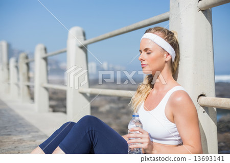 Fit blonde sitting on the pier Fit blonde sitting on the pier 13693141