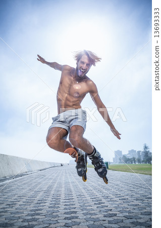 Fit man rollerblading on the promenade Fit man rollerblading on the promenade 13693333