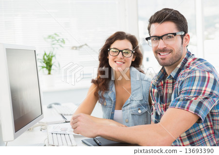 Portrait of smiling colleagues working together Portrait of smiling colleagues working together 13693390