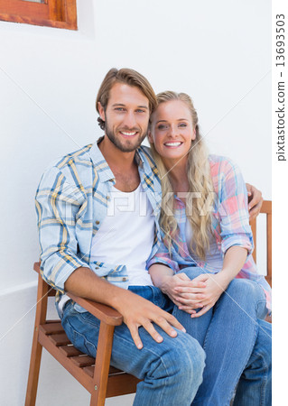 Attractive couple sitting on bench Attractive couple sitting on bench 13693503