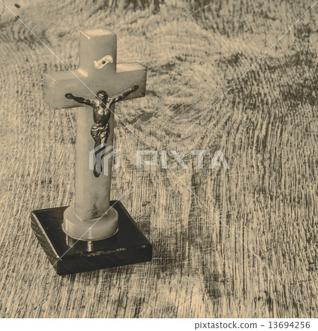 Beautiful old cross with jesus on the old wooden floor Beautiful old cross with jesus on the old wooden floor 13694256