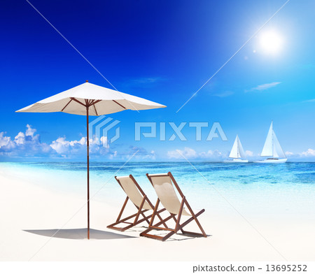 Deck Chairs on Beach with View of Sail Boats 13695252
