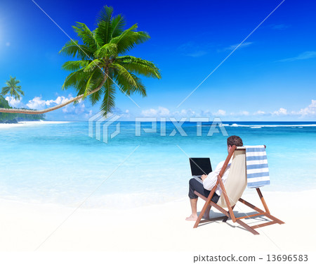 Businessman Working on a Tropical Beach Businessman Working on a Tropical Beach 13696583